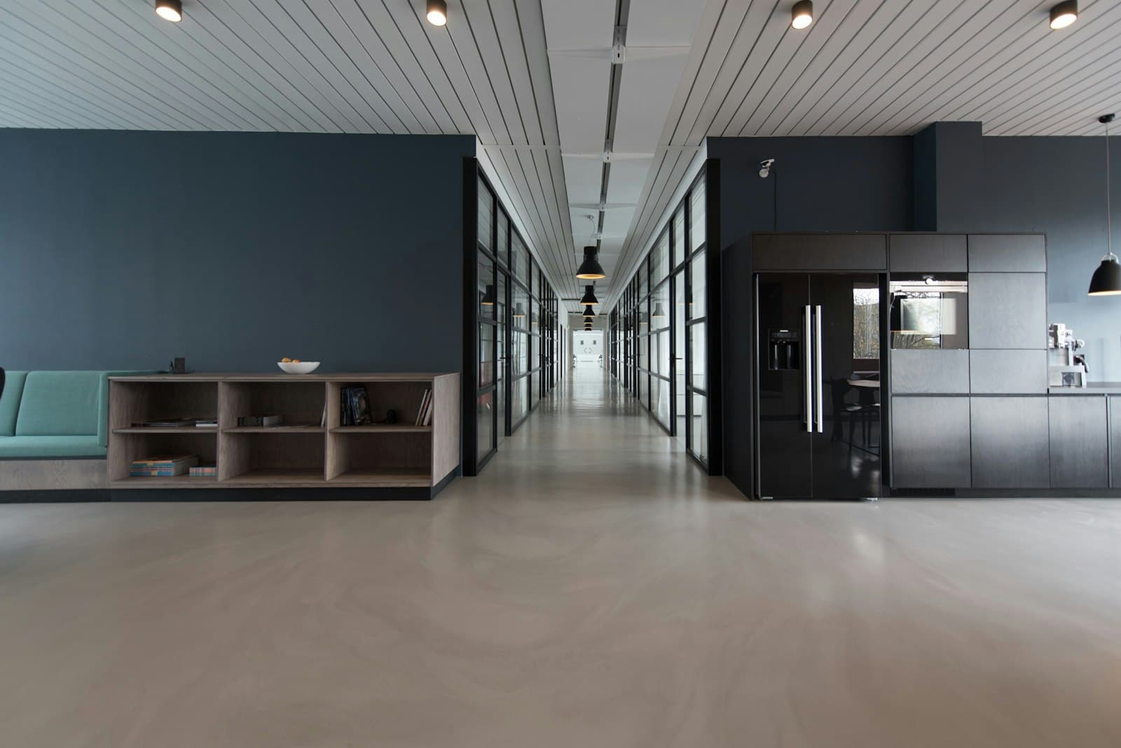 Open-plan office desks under bright overhead lights